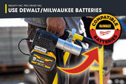Person holding a paver tool with compatibility for Dewalt and Milwaukee batteries, set against a blurred construction site background.