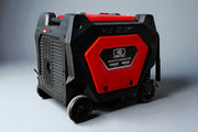 Red and black power tool generator on a gray background