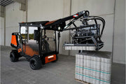 An orange and black S24 PaveJet paver laying machine laying pavers