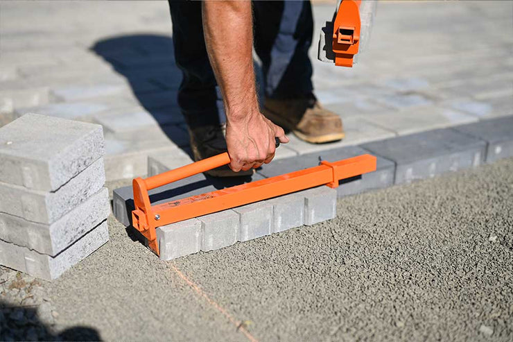 Laying paver with clamp